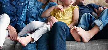 Family sitting on grey couch
